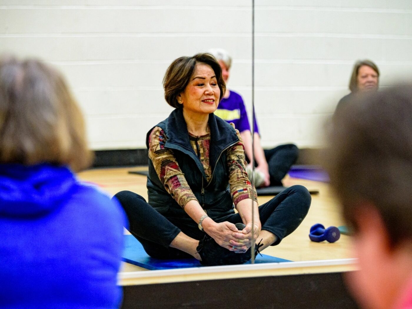 A physiotherapy group working through seated mobility exercises together.